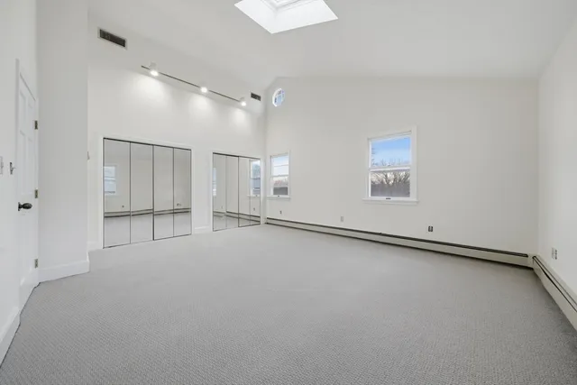 a view of an empty room and a window