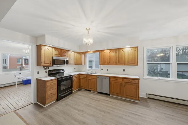 a kitchen with stainless steel appliances granite countertop a stove and a sink