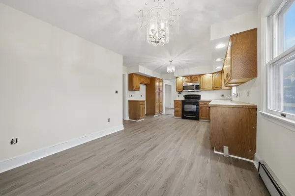 a view of a kitchen with a sink a refrigerator and window