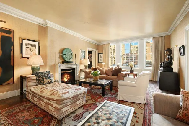 a living room with furniture a rug and a fireplace