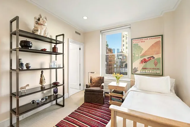 a spacious bedroom with a bed and a couch