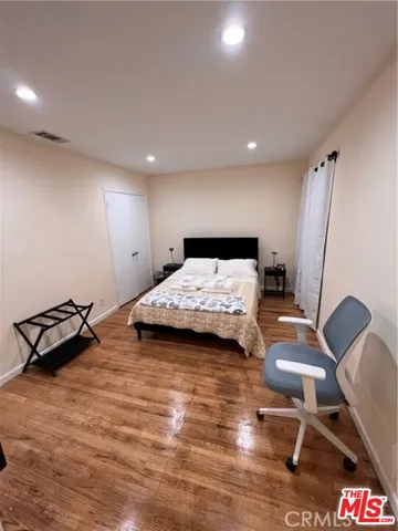 a bedroom with two beds and a large window