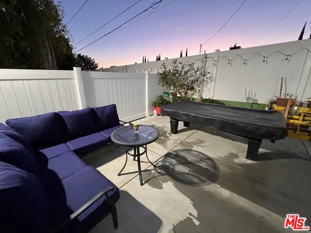 a backyard of a house with table and chairs