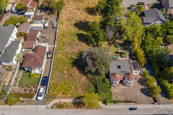 an aerial view of residential houses with outdoor space and swimming pool