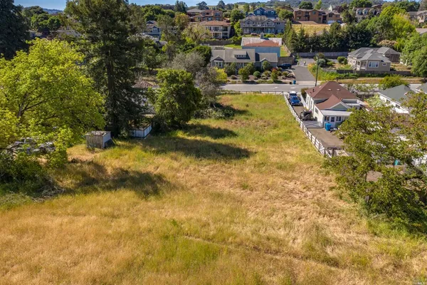 an aerial view of multiple houses with yard