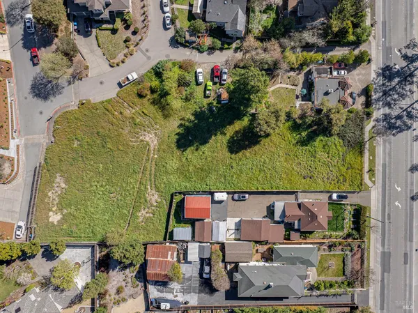 an aerial view of residential houses with outdoor space and swimming pool