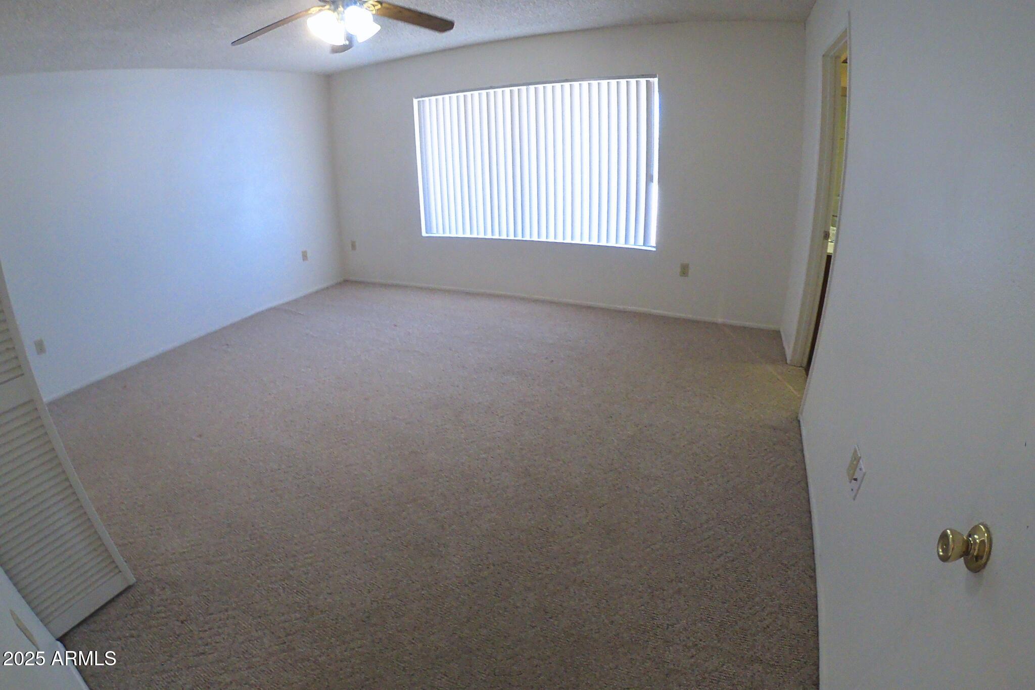 828 East Junction Street, Unit 832 Apache Junction, AZ 85119 - Photo 12 of 17 an empty room with a window