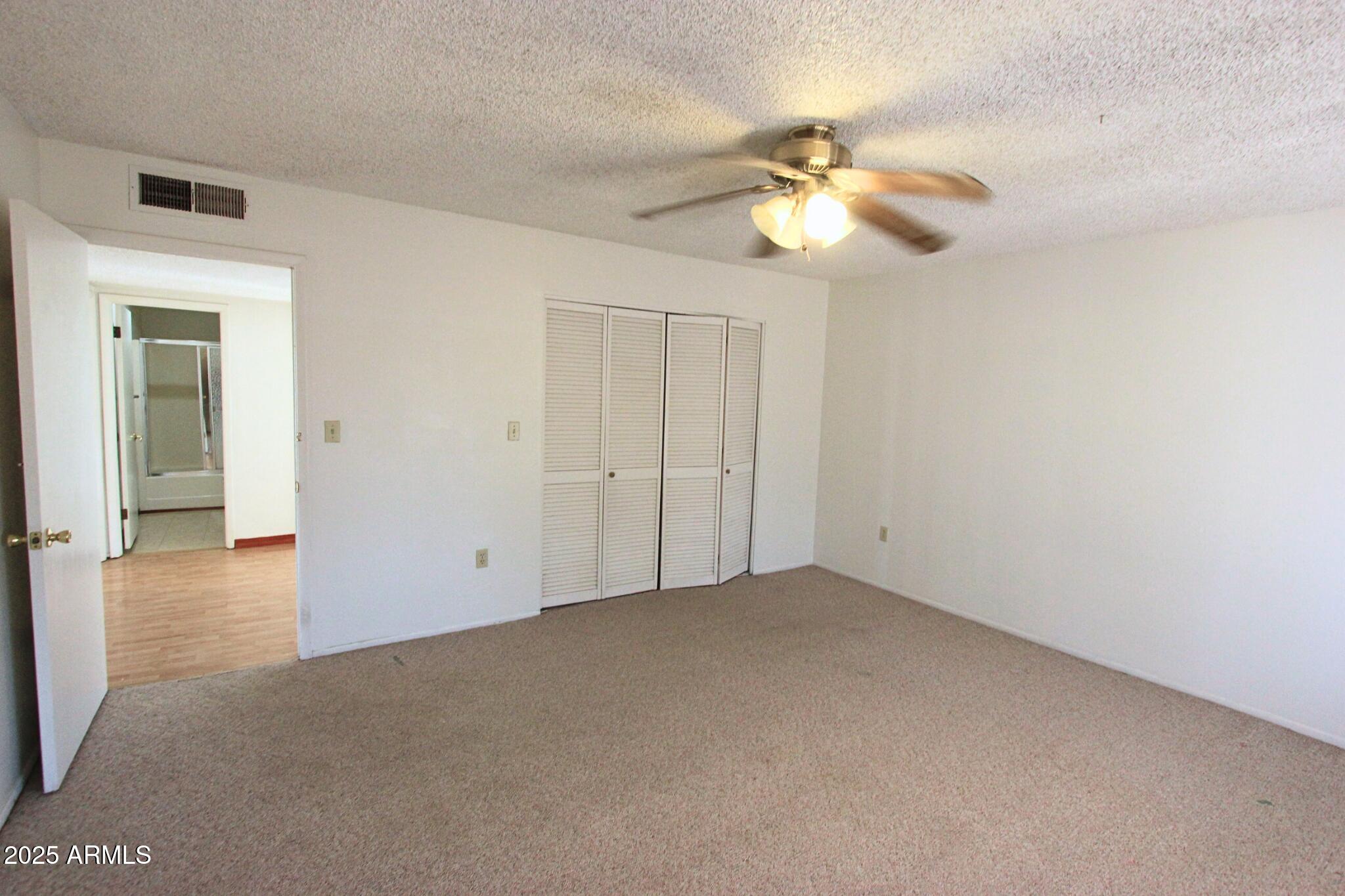 828 East Junction Street, Unit 832 Apache Junction, AZ 85119 - Photo 13 of 17 a view of an empty room with a fan
