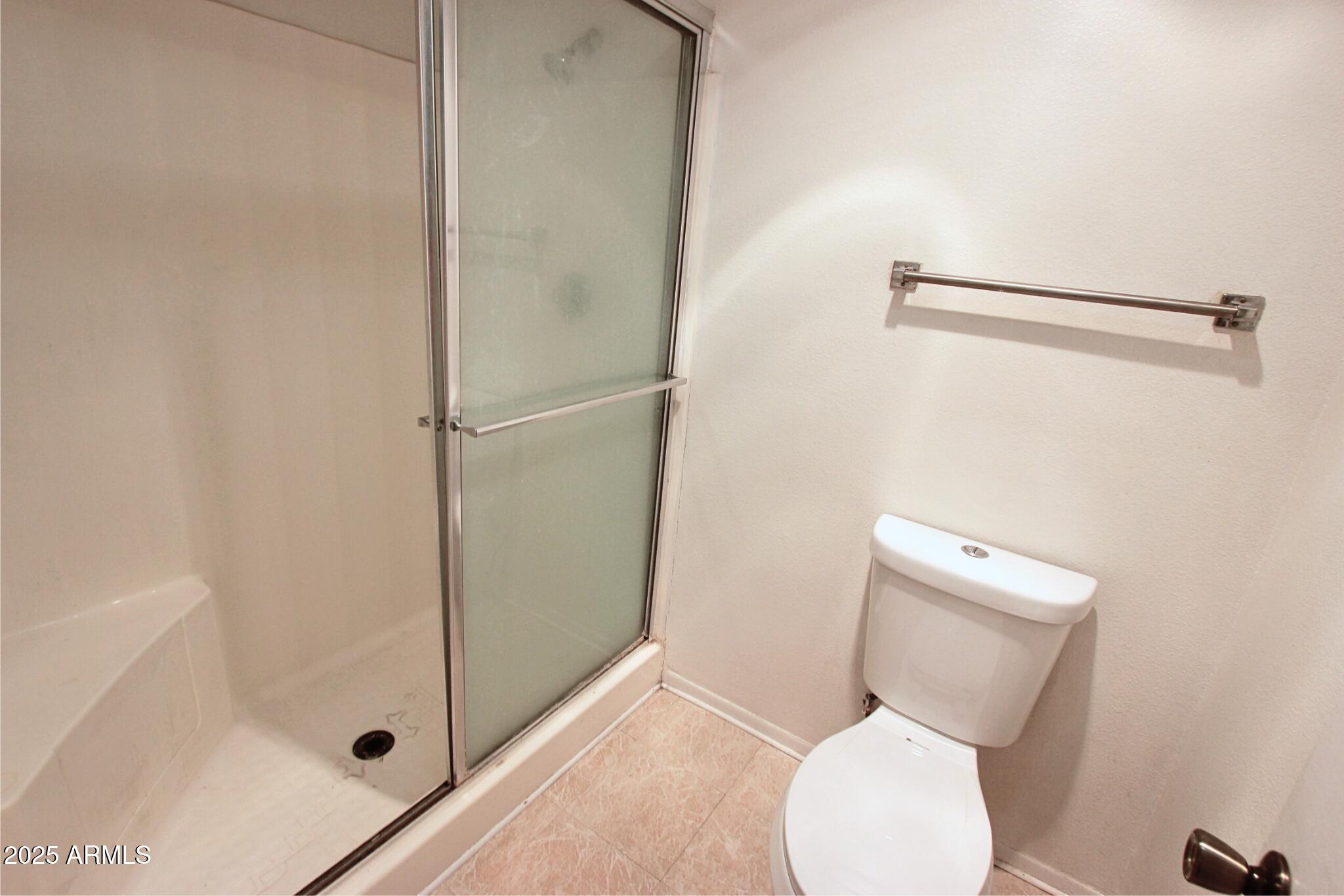 828 East Junction Street, Unit 832 Apache Junction, AZ 85119 - Photo 15 of 17 a white toilet sitting next to a bathroom