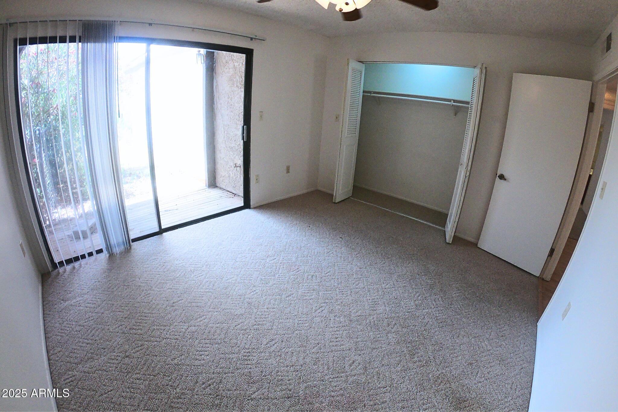 828 East Junction Street, Unit 832 Apache Junction, AZ 85119 - Photo 16 of 17 an empty room with windows and entrance