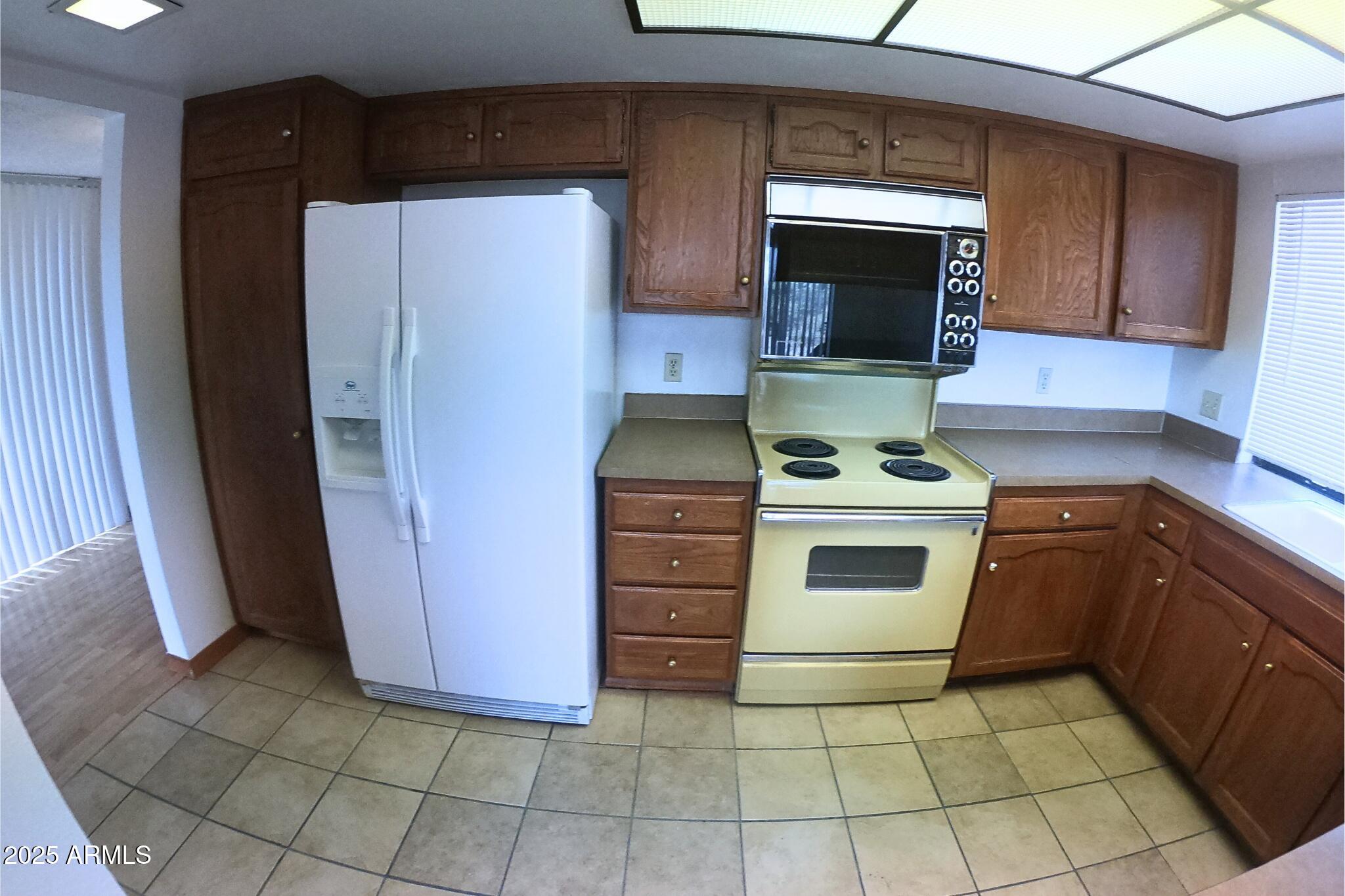828 East Junction Street, Unit 832 Apache Junction, AZ 85119 - Photo 5 of 17 a kitchen with a stove top oven and cabinets