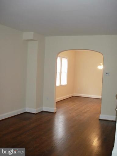 3718 Woodridge Road Baltimore, MD 21229 - Photo 2 of 18 a view of empty room with wooden floor and fan