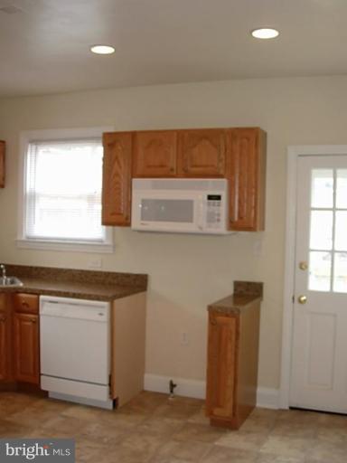 3718 Woodridge Road Baltimore, MD 21229 - Photo 11 of 18 a kitchen with a sink cabinets and window