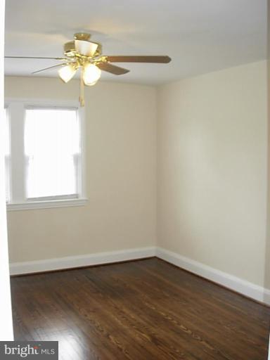 3718 Woodridge Road Baltimore, MD 21229 - Photo 13 of 18 a view of a room with wooden floor and chandelier