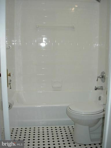 3718 Woodridge Road Baltimore, MD 21229 - Photo 15 of 18 a bathroom with a toilet and a shower