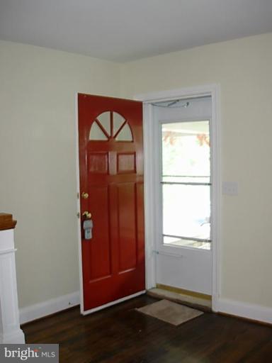 3718 Woodridge Road Baltimore, MD 21229 - Photo 4 of 18 an empty room with wooden floor closet and windows