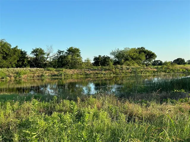 a view of a lake with a yard