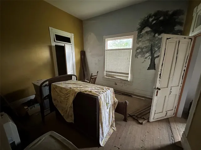 a bedroom with a bed and a mirror