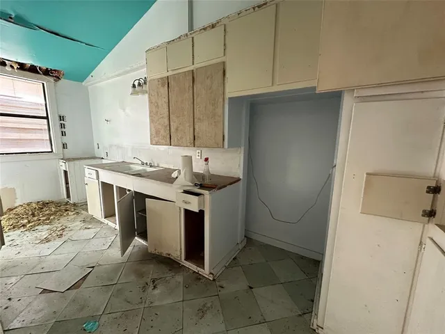a kitchen with a sink a stove and a refrigerator