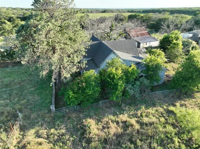 an aerial view of residential house with green space
