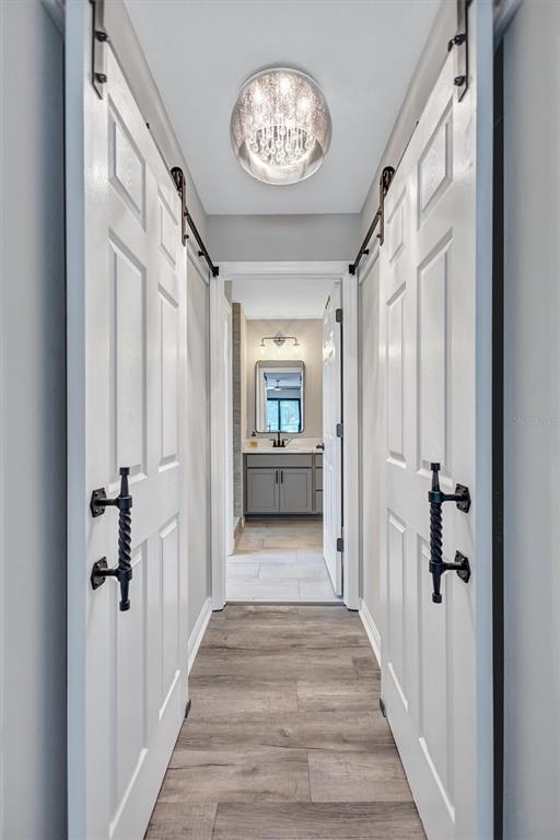 13362 Downy Woodpecker Road Weeki Wachee, FL 34614 - Photo 11 of 26 a view of a hallway view with wooden floor and staircase