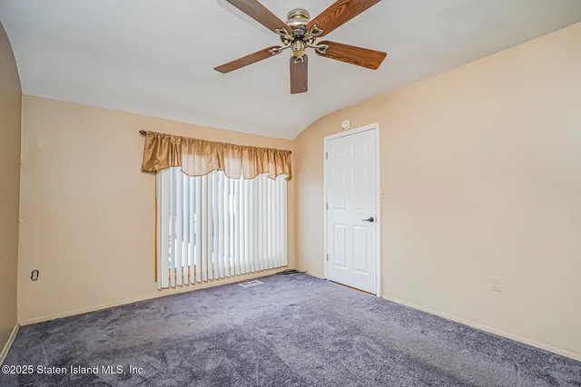 a view of a livingroom with a ceiling fan and window