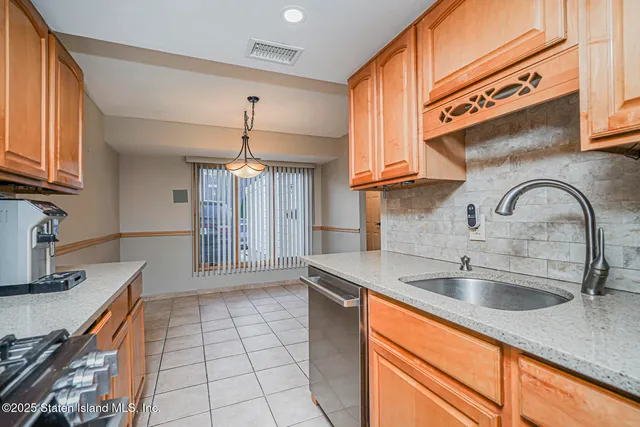 a kitchen with stainless steel appliances granite countertop a sink and cabinets