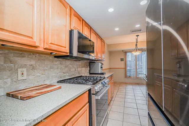 a kitchen with stainless steel appliances a stove a sink and a microwave