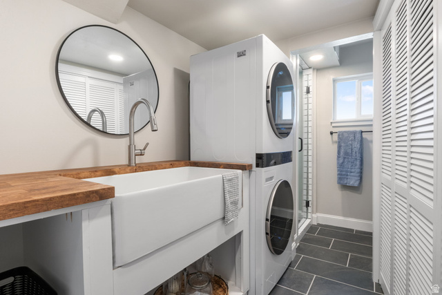415 360 East Salem, UT 84653 - Photo 14 of 20 Laundry area featuring a large farmhouse sink with wood-finish countertops, a stacked washer and dryer unit, and dark slate-style flooring