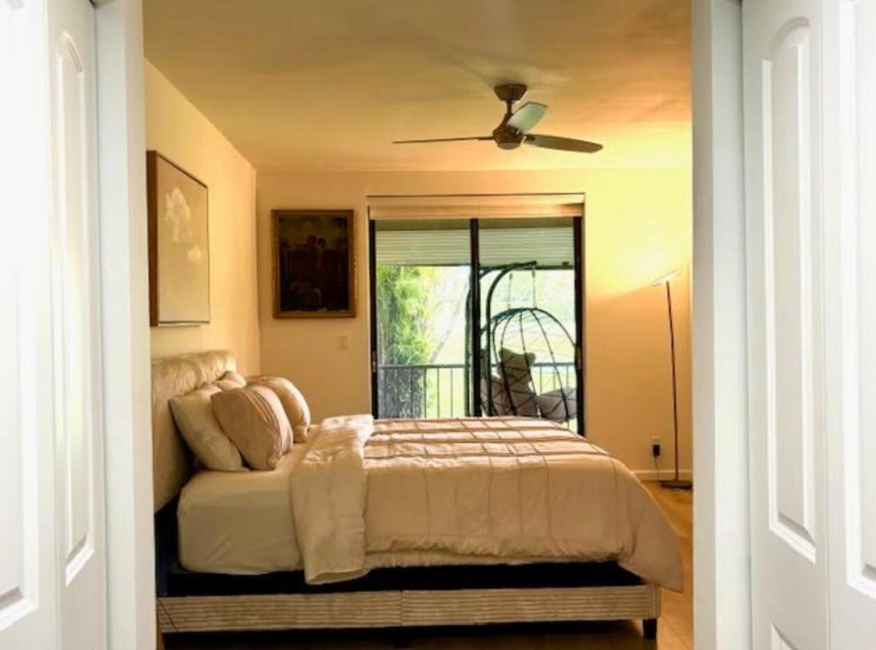 7744 La Mirada Drive Boca Raton, FL 33433 - Photo 13 of 33 a bedroom with a bed and window