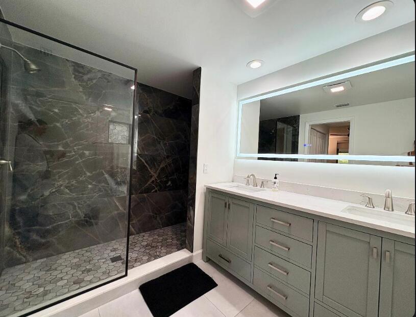 7744 La Mirada Drive Boca Raton, FL 33433 - Photo 17 of 33 a bathroom with a shower sink and mirror