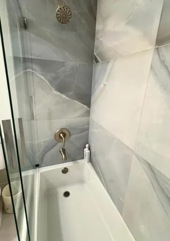 a living room with furniture and a floor to ceiling window