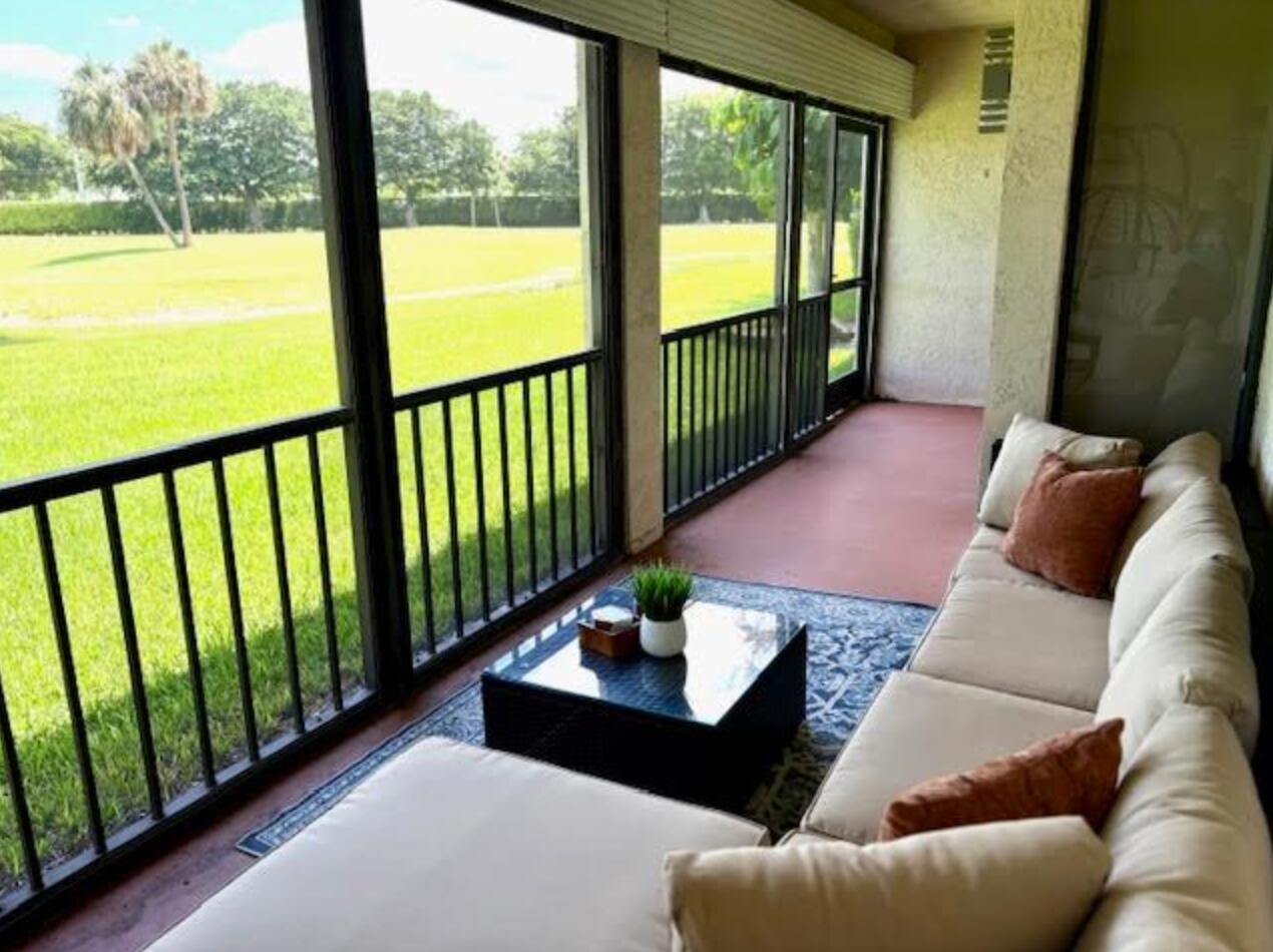 7744 La Mirada Drive Boca Raton, FL 33433 - Photo 27 of 33 a living room with furniture and a floor to ceiling window