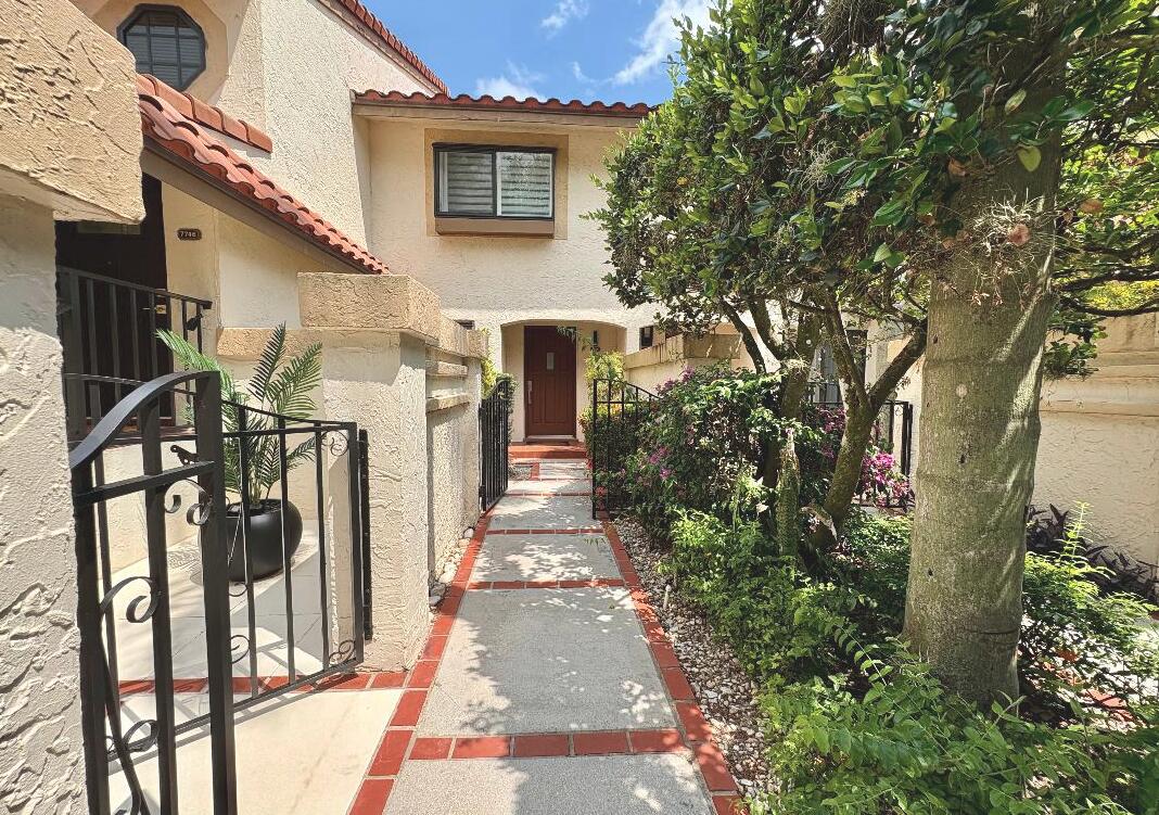 7744 La Mirada Drive Boca Raton, FL 33433 - Photo 3 of 33 a front view of a house with a porch