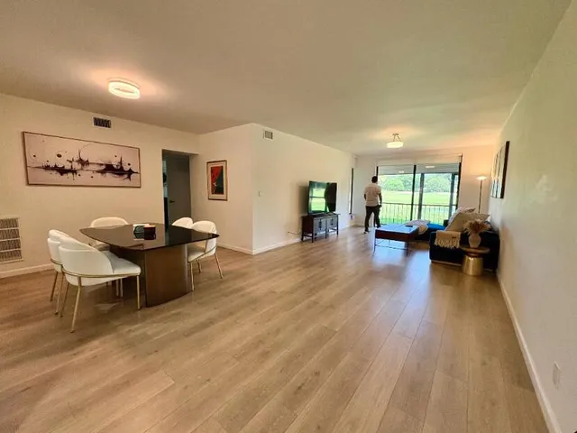 a kitchen with granite countertop a sink a counter top space and cabinets