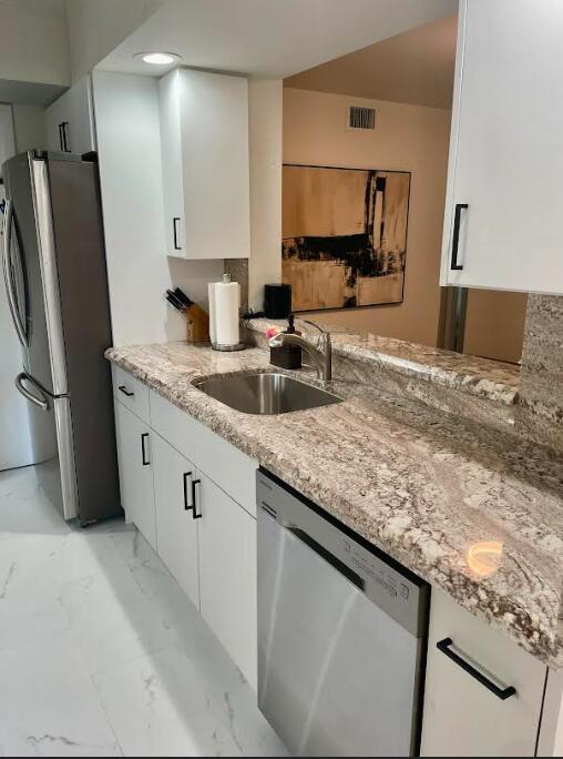 7744 La Mirada Drive Boca Raton, FL 33433 - Photo 10 of 33 a kitchen with granite countertop a sink a counter top space and cabinets