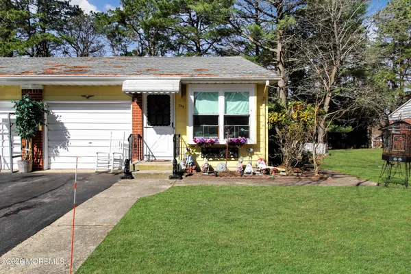 a view of a house with backyard sitting area and garden