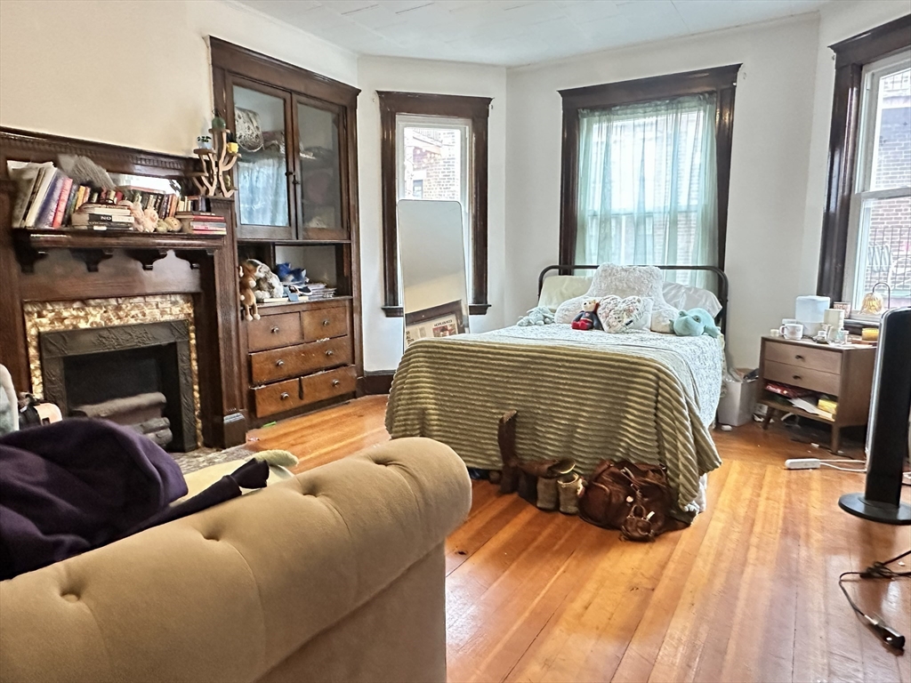 11 Chester Street, Unit 2 Boston, MA 02134 - Photo 3 of 10 a bedroom with two beds and a large mirror