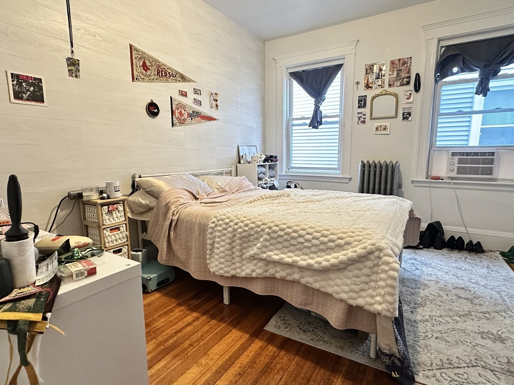 11 Chester Street, Unit 2 Boston, MA 02134 - Photo 4 of 10 a bed sitting in a bedroom next to a window