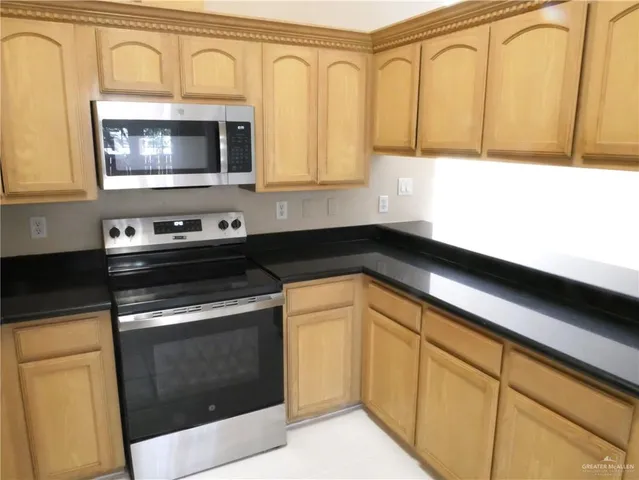 a kitchen with a stove microwave and sink