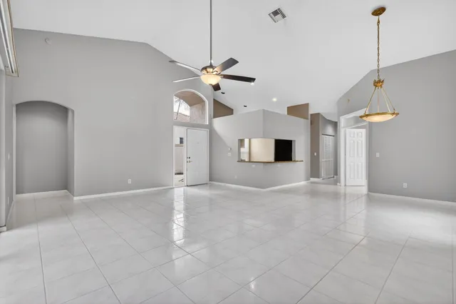 a view of a livingroom with a ceiling fan and entryway