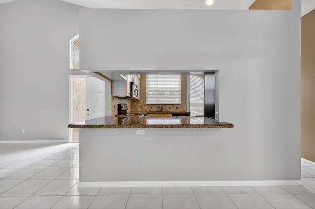 a kitchen with granite countertop a sink and cabinets