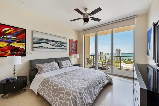 a bedroom with a large bed and a large window