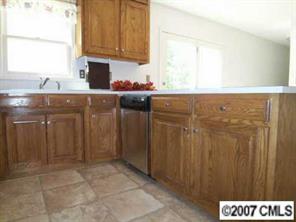 2425 Cherry Lane Denver, NC 28037 - Photo 5 of 8 a kitchen with a sink and cabinets