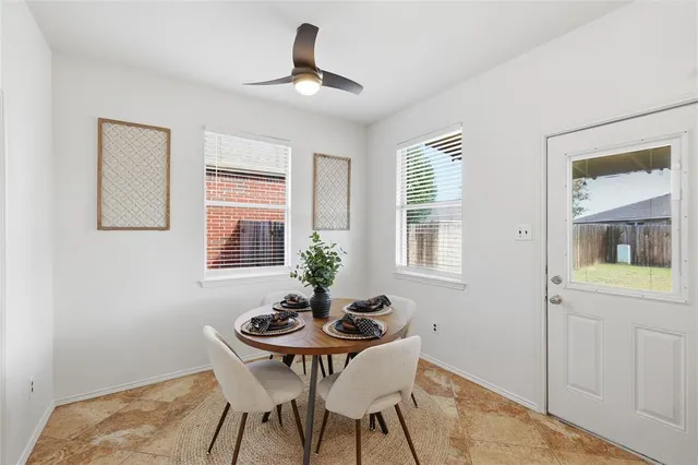 a dining room with furniture and window