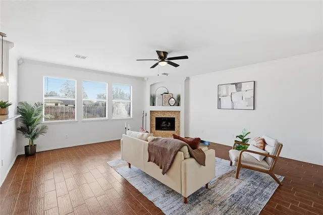 a living room with furniture fireplace and window
