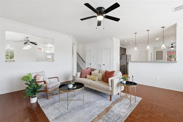 a living room with furniture and a chandelier
