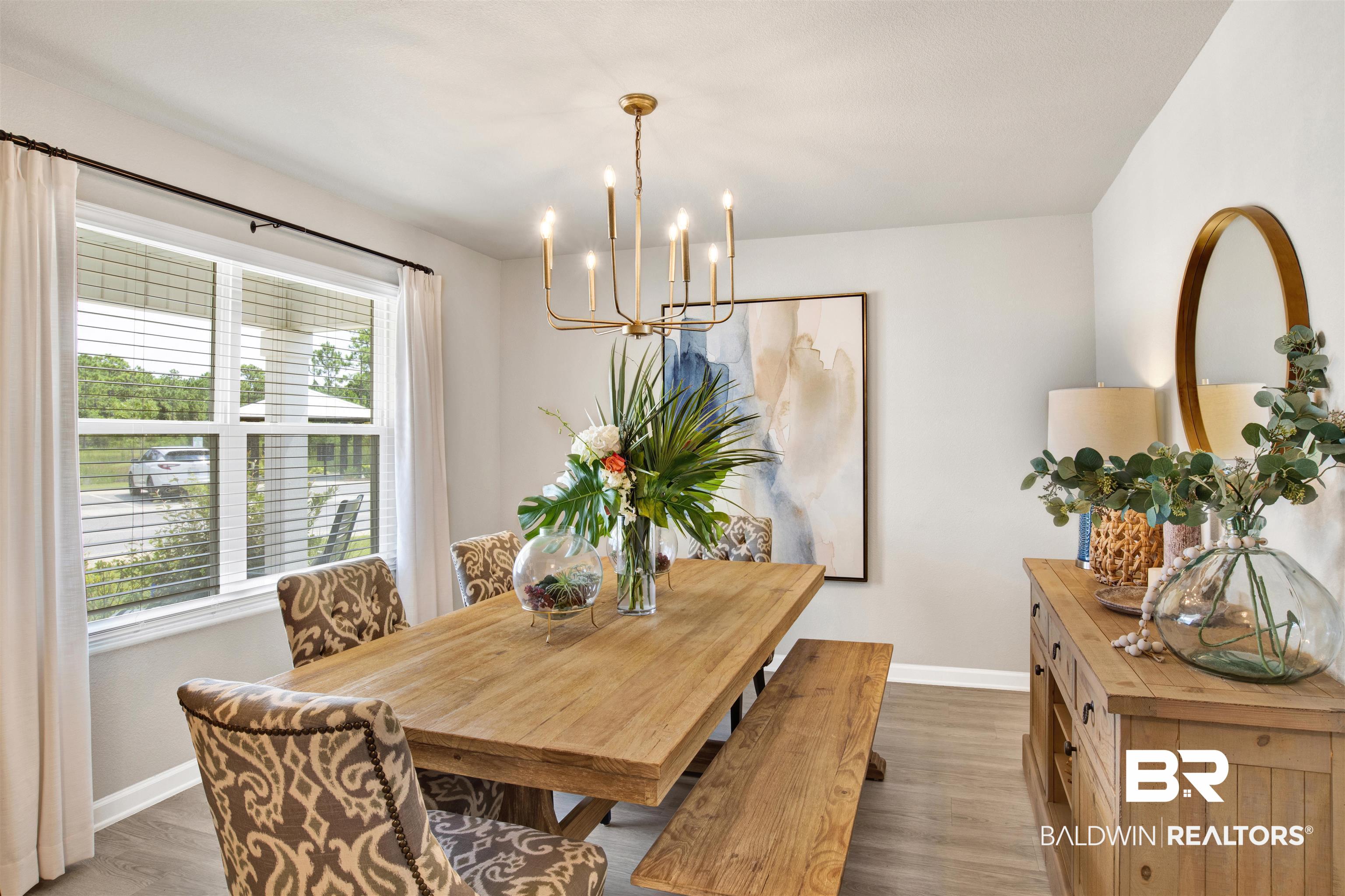 24532 Broken Sound Loop Orange Beach, AL 36561 - Photo 6 of 29 Dining space with a chandelier and dark hardwood / wood-style floors