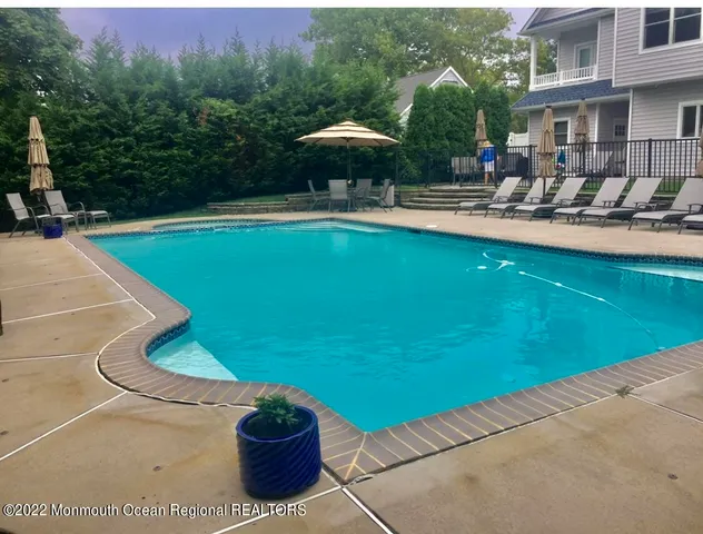 a view of a patio with chairs and plants
