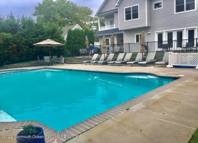 a swimming pool with outdoor seating and yard